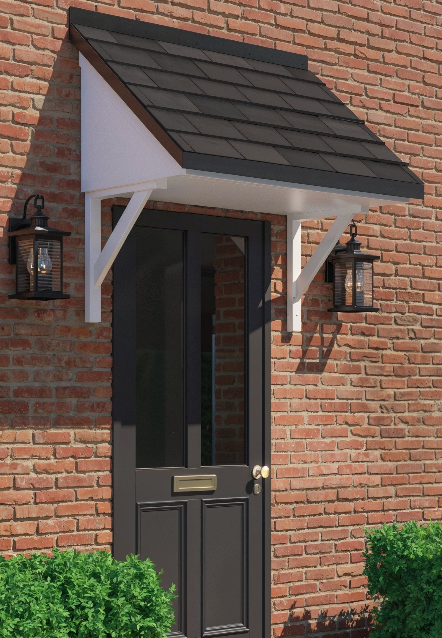 Dark gray door with white trim and black roof on a brick wall, flanked by green bushes.